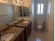 Bathroom showcases a double vanity, framed mirrors, and natural light at 7426 Trudy Ln, Las Vegas, NV 89123