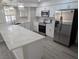 Modern kitchen with white cabinets, stainless steel appliances, and quartz countertops at 7426 Trudy Ln, Las Vegas, NV 89123