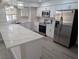 Modern kitchen with white cabinets, stainless steel appliances, and quartz countertops at 7426 Trudy Ln, Las Vegas, NV 89123