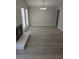 Bright living room with fireplace, recessed lights and light gray, wood-look floors at 7426 Trudy Ln, Las Vegas, NV 89123