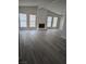 Spacious living room with a fireplace, new flooring, and ample natural light from large windows at 7426 Trudy Ln, Las Vegas, NV 89123