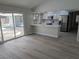Open living space with eat-in kitchen, wood-look floors and access to the backyard at 7426 Trudy Ln, Las Vegas, NV 89123