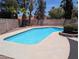 Backyard view of refreshing pool with a stone fence for privacy at 7426 Trudy Ln, Las Vegas, NV 89123