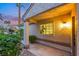 Front porch with decorative pillars and lush landscaping, offering a charming entrance at 7701 Sea Cliff Way, Las Vegas, NV 89128