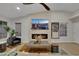 Bright living room features a modern fireplace and ceiling fan at 7701 Sea Cliff Way, Las Vegas, NV 89128