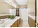 Well-lit bathroom featuring a double sink vanity and shower-tub combo at 8620 Copper Mountain Ave, Las Vegas, NV 89129