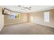 Large bedroom with a ceiling fan, a TV, and a window with natural light at 8620 Copper Mountain Ave, Las Vegas, NV 89129