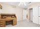 Neutral bedroom featuring a wooden desk and closet space at 8620 Copper Mountain Ave, Las Vegas, NV 89129