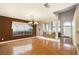 Open dining room with hardwood floors, chandelier, and view to staircase at 8620 Copper Mountain Ave, Las Vegas, NV 89129