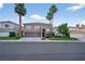 Exterior of two-story home with mature landscaping, a three car garage and tiled roof at 8620 Copper Mountain Ave, Las Vegas, NV 89129