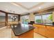 Bright kitchen island and sink area with backyard pool view and connected dining space at 8620 Copper Mountain Ave, Las Vegas, NV 89129
