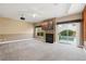 Bright living room with a fireplace, large windows overlooking the pool and outdoor space at 8620 Copper Mountain Ave, Las Vegas, NV 89129
