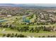An aerial shot displays the lush golf course community with lakes and greens, providing serene views and recreational opportunities at 9308 Pitching Wedge Dr, Las Vegas, NV 89134