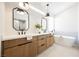 Luxurious bathroom features a dual sink vanity, a freestanding tub, and modern fixtures and finishes at 9308 Pitching Wedge Dr, Las Vegas, NV 89134