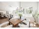 Bright dining area with modern chandelier, wood table, and open access to a stunning kitchen at 9308 Pitching Wedge Dr, Las Vegas, NV 89134
