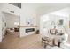 Open concept living area boasts a fireplace feature wall, high ceilings, and an adjoining dining area at 9308 Pitching Wedge Dr, Las Vegas, NV 89134