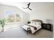 Bright bedroom with ceiling fan, neutral carpet, and large windows overlooking the exterior at 9308 Pitching Wedge Dr, Las Vegas, NV 89134