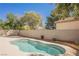 Inviting pool surrounded by a neutral-colored stone deck and lush landscaping at 9308 Pitching Wedge Dr, Las Vegas, NV 89134
