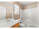 Bright bathroom with a single sink vanity, white cabinets, tub and shower combination, and neutral walls at 9338 Square Dance Pl # 101, Las Vegas, NV 89178