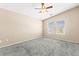 Cozy bedroom featuring a ceiling fan, neutral walls, and plush carpeting at 9338 Square Dance Pl # 101, Las Vegas, NV 89178