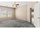 Bedroom with two windows, ceiling fan, neutral walls, and carpet at 9338 Square Dance Pl # 101, Las Vegas, NV 89178