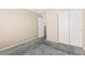Cozy bedroom featuring neutral walls, plush carpet, and a closet with a view to the hallway at 9338 Square Dance Pl # 101, Las Vegas, NV 89178