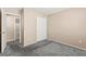 Bedroom with neutral walls, carpet, closet with sliding doors, and a view to the hallway at 9338 Square Dance Pl # 101, Las Vegas, NV 89178