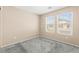 Bright bedroom featuring neutral walls, plush carpet, and double windows for ample natural light at 9338 Square Dance Pl # 101, Las Vegas, NV 89178