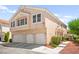 Side view of a multi-Gathering home with a three-car garage and manicured landscaping at 9338 Square Dance Pl # 101, Las Vegas, NV 89178