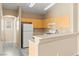 Bright kitchen featuring light wood cabinets and modern appliances at 9338 Square Dance Pl # 101, Las Vegas, NV 89178