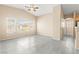 Bright, open living room featuring large windows and modern gray flooring at 9338 Square Dance Pl # 101, Las Vegas, NV 89178