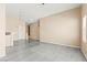 Inviting living room with a view of the kitchen and modern gray flooring at 9338 Square Dance Pl # 101, Las Vegas, NV 89178
