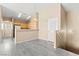 Bright, open living room with neutral tones, wood floors, and a view into the kitchen at 9338 Square Dance Pl # 101, Las Vegas, NV 89178
