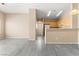 Open-concept living room with a view of the kitchen and modern gray flooring at 9338 Square Dance Pl # 101, Las Vegas, NV 89178