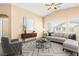 Bright living room featuring a ceiling fan, neutral paint, lots of natural light and modern furnishings at 9338 Square Dance Pl # 101, Las Vegas, NV 89178