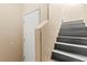 Staircase with gray wood steps and a white door at 9338 Square Dance Pl # 101, Las Vegas, NV 89178