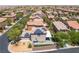 Sweeping aerial perspective highlighting rooftops adorned with solar panels in a desert community at 9373 Wild Lariat Ave, Las Vegas, NV 89178