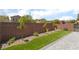 Landscaped backyard with artificial grass, brick pavers, rock and privacy wall at 9373 Wild Lariat Ave, Las Vegas, NV 89178