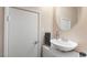 A half bathroom features a white vessel sink and door at 9373 Wild Lariat Ave, Las Vegas, NV 89178