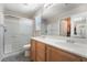 A bathroom with double sinks, a shower, and a mirrored view of a closet at 9373 Wild Lariat Ave, Las Vegas, NV 89178