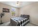 Cozy bedroom features a ceiling fan, and a window for natural light at 9373 Wild Lariat Ave, Las Vegas, NV 89178