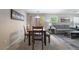 Open-concept dining area featuring a wooden table, modern lighting, and access to the living room at 9373 Wild Lariat Ave, Las Vegas, NV 89178