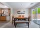 Bright dining area with a wooden table, bench seating, and sliding glass doors at 9373 Wild Lariat Ave, Las Vegas, NV 89178