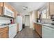 Functional kitchen with white appliances, light wood cabinets, and ample counter space at 9373 Wild Lariat Ave, Las Vegas, NV 89178