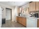 Well-equipped kitchen with white appliances, light wood cabinets, and practical layout at 9373 Wild Lariat Ave, Las Vegas, NV 89178