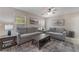 Cozy living room with stylish furniture, a ceiling fan, and a large window at 9373 Wild Lariat Ave, Las Vegas, NV 89178