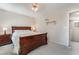 A comfortable bedroom with a wooden bed, ceiling fan and a dresser at 9373 Wild Lariat Ave, Las Vegas, NV 89178