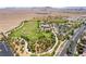 Overhead view of a sports complex with a multi-use green space and baseball diamonds amid a desert community at 9373 Wild Lariat Ave, Las Vegas, NV 89178