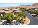Charming neighborhood street view showcasing well-maintained homes, lush greenery, and a picturesque mountain backdrop at 9373 Wild Lariat Ave, Las Vegas, NV 89178
