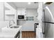 Efficient kitchen with stainless steel appliances, white countertop, and updated fixtures at 9572 Belle Rich St, Las Vegas, NV 89123